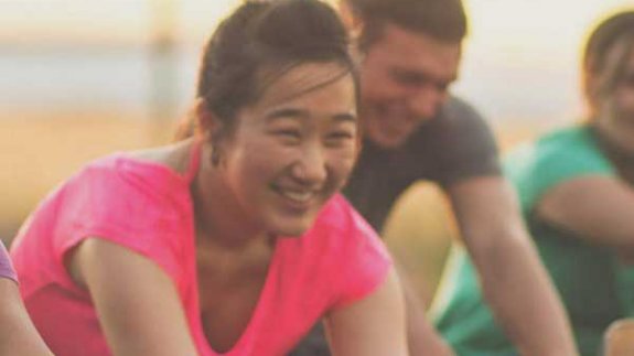 Image of a woman smiling while exercising